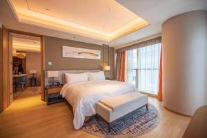 Postel nebo postele na pokoji v ubytování HongQiao Primus Residence Apartment - National Exhibition Center + 37 fotografií
