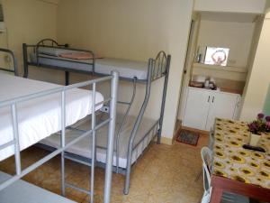 a room with two bunk beds and a table at Casa Corazon Transient House in Casboran