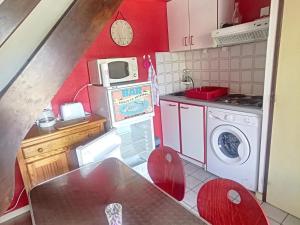 a small kitchen with a stove and a microwave at Maison Argelès-sur-Mer, 3 pièces, 5 personnes - FR-1-732-45 in Argelès-sur-Mer