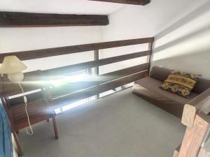 a bed in a room with a lamp and a couch at Pavillon climatisé avec terrasse, 10 min. de la plage, parking privatif inclus, tout confort - FR-1-732-45 in Argelès-sur-Mer