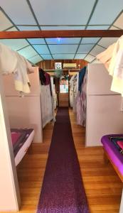 a room filled with lots of racks of clothes at AA Backpackers Hostel in Pantai Cenang