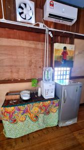 a miniature kitchen with a stove and a refrigerator at AA Backpackers Hostel in Pantai Cenang