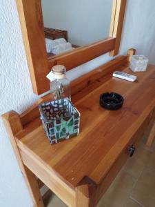 a table with a mirror and a bottle on it at Loggia Two in Agia Galini