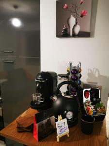 a table with a coffee maker and a tea kettle at Grand Studio à la Défense in Courbevoie