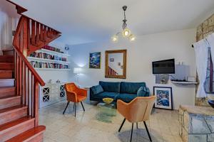 a living room with a blue couch and chairs at Holiday house with a swimming pool Smokvica, Korcula - 9297 in Smokvica