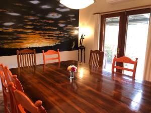 a dining room with a large wooden table and chairs at Meriba B and B in Bundanoon