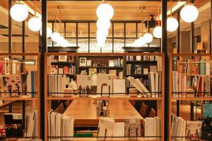 a library filled with lots of books on shelves at Art Hotel Osaka Bay Tower in Osaka