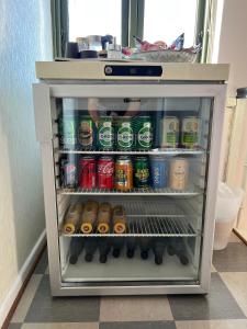 a refrigerator filled with lots of sodas and drinks at JM B&B in Sakskøbing