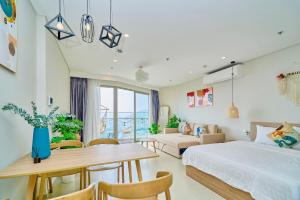a bedroom with a bed and a table and chairs at The Song Vung Tau Near Beach in Vung Tau