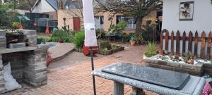 un cortile posteriore con patio in mattoni e camino di The Cottage Unit a Bloemfontein