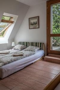 a bedroom with a bed and a window at chalupa Pod Metodkou in Věcov