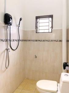 a bathroom with a shower and a toilet at Nestle Homestay@Batu Pahat in Batu Pahat