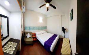 a bedroom with a bed and a ceiling fan at Casa Puerto Bonito & Private Coworking in Puerto Escondido +37 photos