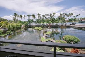 a view from the balcony of a resort with a pond at SCP Hilo Hotel in Hilo