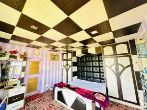 a room with a checkered ceiling with a bed in it at Sheen Homestay in Gulmarg