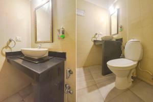 bagno con servizi igienici bianchi e lavandino di FabExpress Paradise Inn Panaji a Goa Velha