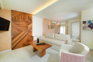 a living room with a white couch and a table at Dagos Luxury Apartments in Limenas