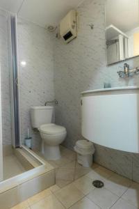a bathroom with a toilet and a sink and a shower at Annas Horizon in Samothraki