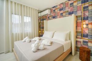 a bedroom with two white towels on a bed at Dagos Luxury Apartments in Limenas