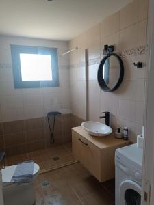 a bathroom with a sink and a toilet and a mirror at VILLA STEFANIA in Érfoi