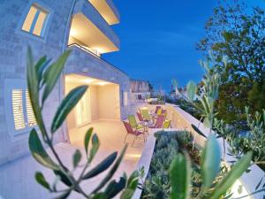 a house with a patio with chairs and plants at Dubrovnik Icy Guest House in Dubrovnik