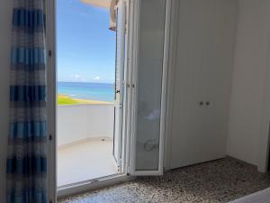 a bathroom with a shower with a view of the ocean at Hotel Castelsardo Domus Beach in Castelsardo