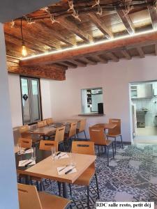 a dining room with wooden tables and chairs at AU BOL D'AIR in Saint-Appolinaire