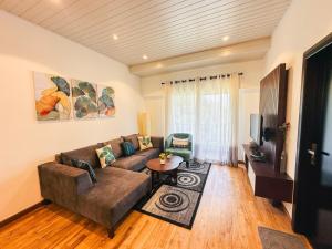 a living room with a couch and a tv at The Edge Luxury Apartment in Nuwara Eliya