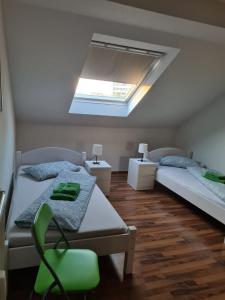 a bedroom with two beds and a skylight at Appartement Krefeld-City in Krefeld