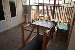 a room with a table and chairs on a balcony at Art Guest House USTO in Bukhara +38 photos