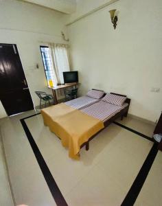 a bedroom with a bed in the middle of a room at Rosh Tower in Trivandrum