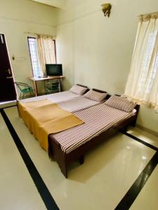 a bedroom with a large bed in a room at Rosh Tower in Trivandrum