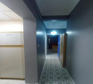 an empty hallway with a blue wall and a hallway with a hallway at My Home Taksim in Istanbul