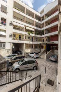 a parking lot with cars parked in front of a building at Apartment FORTUNA in Split