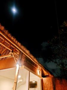 a light on the side of a building at night at Happiness Villa 1BR+Private Pool @Seminyak in Seminyak