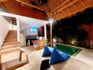 a house with a swimming pool and a table and stairs at Happiness Villa 1BR+Private Pool @Seminyak in Seminyak