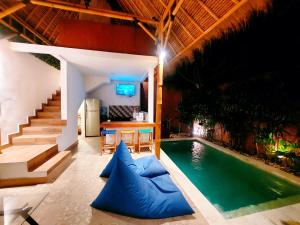 a swimming pool in a house with a table and a television at Happiness Villa 1BR+Private Pool @Seminyak in Seminyak