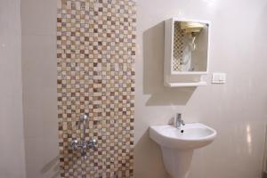a bathroom with a sink and a mirror at Coorg Nature Breeze Homestay in Madikeri