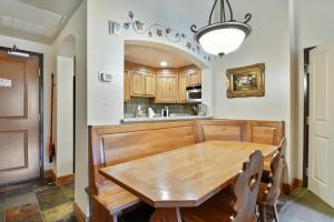 a dining room with a wooden table and a kitchen at Adventure Hub-Ski Resorts, Backcountry & Park City 3011 villa in Midway