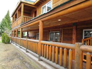 a large wooden house with a wooden railing at Yellowstone Country Inn in West Yellowstone