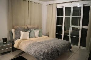 a bedroom with a bed and a large window at EL Paraiso in La Pared