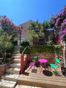 a group of chairs and a table on a patio at Abri du vent, chambres et appartements in Fitou