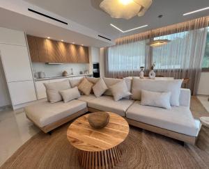 a living room with a couch and a table at Meliora Exclusive Villas Parga in Parga
