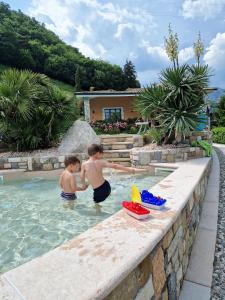 Zwei Jungs spielen im Schwimmbad. in der Unterkunft Residence Terry in Tremosine sul Garda