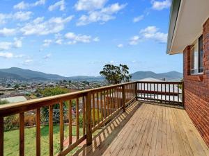 a wooden balcony with a view of the city at Spacious Home in West Moonah, Hobart in Moonah