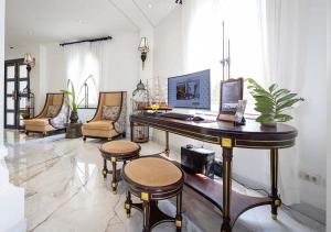 a room with a desk with a laptop and chairs at Le Thatluang D'oR Boutique Hotel in Vientiane