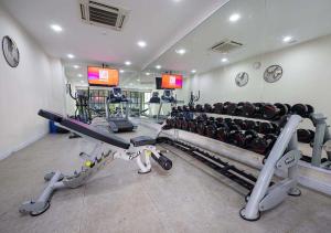 a fitness room with a gym with tread machines at Le Thatluang D'oR Boutique Hotel in Vientiane