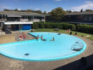 a group of people in a large swimming pool at Appartementen Zuiderstrand H in Westkapelle