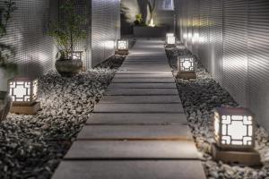 a walkway in a building with lights and rocks at Guangzhou Shug Art Hotel in Guangzhou