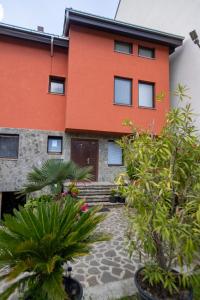 an orange building with plants in front of it at Pejik apartment in Ohrid